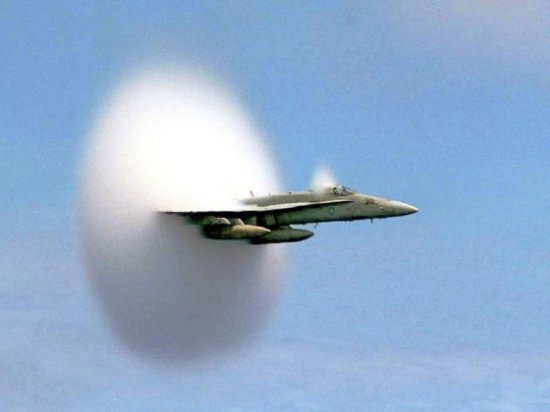 Shock wave formed by F-18 exceeding Mach 1