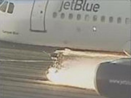Sparks and fire from the twisted nose gear as the A320 lands