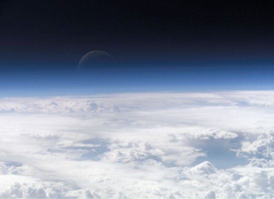 Earth's blue atmosphere above the tops of water ice clouds