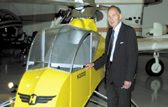 Stanley Hiller, Jr. beside his first helicopter, the XH-44, at the Smithsonian