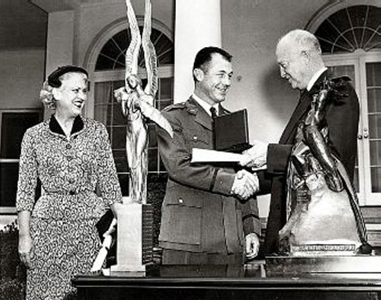 Jackie Cochran and Chuck Yeager receiving trophies from Pres. Eisenhower