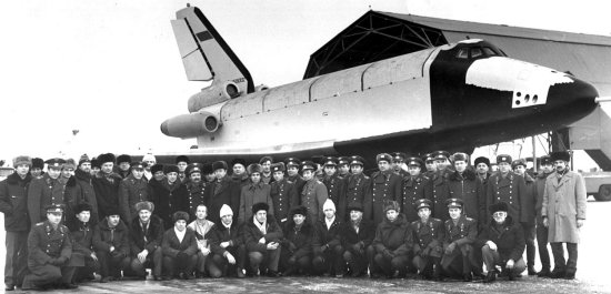 Flight test team posing in front of the Analog Buran with three engine nacelles visible on the tail
